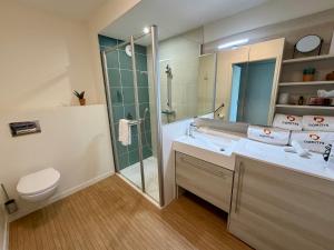 a bathroom with a shower and a sink and a toilet at DOMITYS - Purpan Pèira Ròsa in Toulouse +5 photos