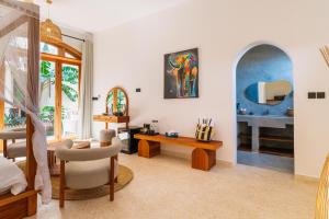 a living room with a couch and a table at Casa Rodi Zanzibar in Jambiani