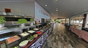 a buffet line in a restaurant with plates of food at Aloria Garden Hotel in Erdek +26 photos