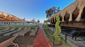 a row of chairs and umbrellas in a resort at Aloria Garden Hotel in Erdek