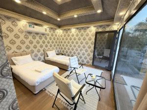 a small room with a bed and a couch and a table at Neem camp in Nizwa