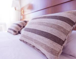 a row of pillows sitting on a bed at Tharusha Hotel in Udawalawe