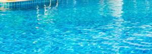 a blue pool of water with a reflection in it at Tharusha Hotel in Udawalawe