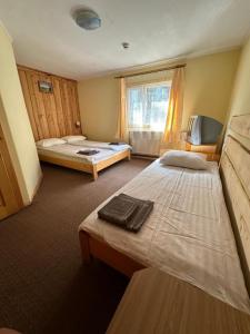 a room with two beds and a window at Plai in Dragobrat