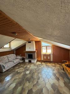 a large living room with a couch and a fireplace at La Mansarda del Vecchio Mulino in Entracque