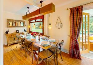 a dining room with a wooden table and chairs at Kinloch Lodge in Drumnadrochit