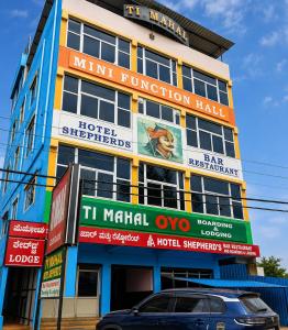 a building with signs on the side of it at Hotel Shepherds in Bīdar