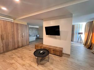 a living room with a television on a wall at Prenoćište Nikolić in Negotin