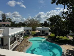 a swimming pool in front of a house at M&H Boutique Hotel in Mombasa