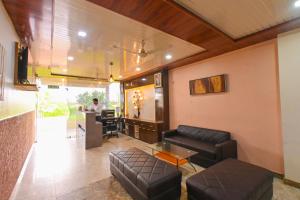 a living room with leather furniture and a bar at Hotel Dhola Maru in Kota