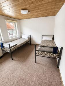 two bunk beds in a room with a ceiling at Workers House in Bockenem