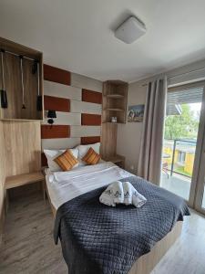 a bedroom with a bed with a hat on it at Jastra-Bay in Jastarnia