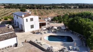 an aerial view of a house with a swimming pool at Agriturismo Masseria Saittole in Carpignano Salentino