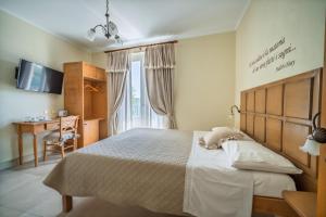 a bedroom with a large bed and a desk at ChocoHouse in Ragusa