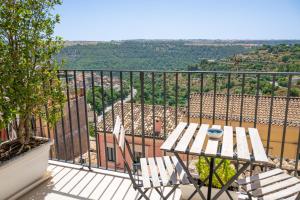 a table and chairs on a balcony with a view at ChocoHouse in Ragusa