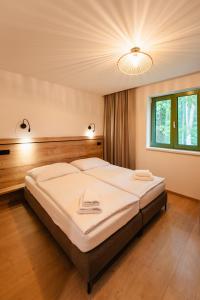 a bedroom with a large bed in a room at PÚŠŤ rekreačné stredisko in Prievidza