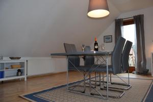 a dining room with a blue table and chairs at Wichmann, Ursula & Axel in Schönberg