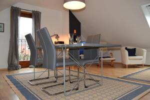 a dining room with a table and chairs at Wichmann, Ursula & Axel in Schönberg