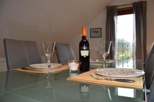 a bottle of wine sitting on a table with glasses at Wichmann, Ursula & Axel in Schönberg +13 photos