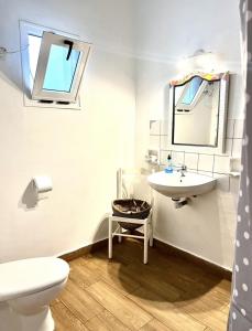 a white bathroom with a sink and a toilet at El Hostal del Cubo in San Juan de la Rambla