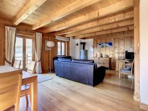 a large living room with wooden walls and wooden floors at Laiterie 1 in Verbier +18 photos