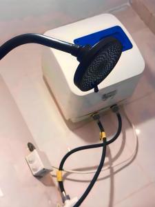 a hair brush sitting on top of a toaster at ZANZInest Apartment in Kituoni
