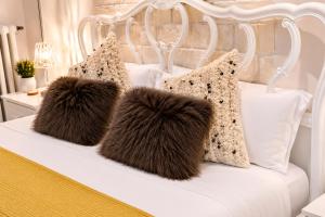 a white bed with two fluffy pillows on it at BB Naviglio Milano Centro in Milan +39 photos