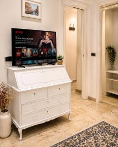 a white dresser with a tv on top of it at BB Naviglio Milano Centro in Milan