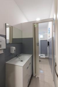 a bathroom with a white sink and a mirror at Change The World Hostels - Cascais - Estoril in Monte Estoril +112 photos