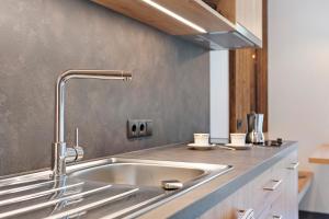 a kitchen with a stainless steel sink in a kitchen at Oberstarzerhof in Barbiano +50 photos