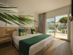 a bedroom with a large bed and a large window at BQ Paguera Boutique Hotel - Adults Only in Paguera +72 photos