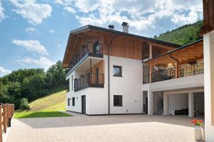 a large white building with balconies on it at Oberstarzerhof in Barbiano
