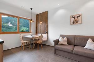 a living room with a couch and a table at Oberstarzerhof in Barbiano