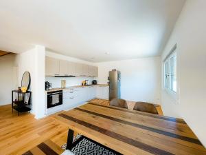 a kitchen and living room with a wooden floor at 3S Holiday Home in Traunstein +7 photos