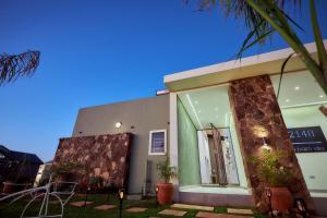 a building with a window and plants in front of it at Pomona Palm Villa in Harare