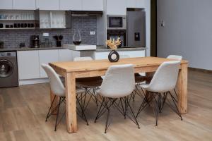 a wooden table and chairs in a kitchen at Pomona Palm Villa in Harare