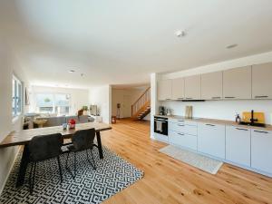 a kitchen with a table and chairs in a room at 3S Holiday Home in Traunstein