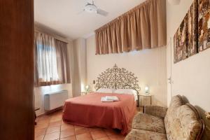 a bedroom with a bed and a couch at Le Civette Country Resort with Pool in Bagno a Ripoli +65 photos