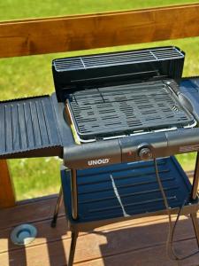 a grill sitting on top of a picnic table at Glamping Pod Hradom súkromné jacuzzi a sauna in Bardejov