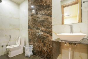 a bathroom with a sink and a toilet at Hotel Al Aziz Palace 30 Mts from Dargah Sharif in Ajmer