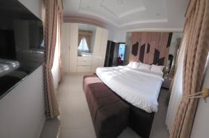 a bedroom with a bed and a couch at MDY Apartments in Ile-Ife