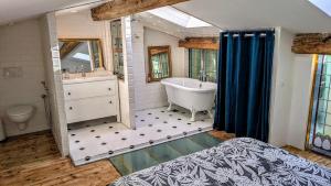 a large bathroom with a tub and a sink at 1860 Bordeaux - Lormont house in Lormont +35 photos