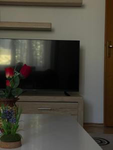 a flat screen tv sitting on top of a dresser at Squarehouse Apartment Prishtina in Prishtinë +13 photos