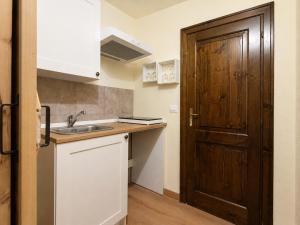 a kitchen with a sink and a wooden door at Casa Runcis in Cavasso Nuovo +7 photos