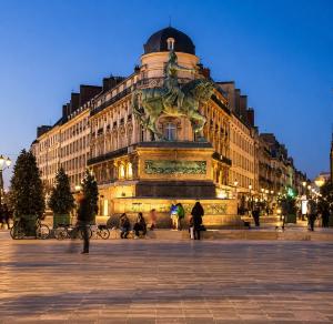 a large building with a statue in front of it at Suite O'Dream - Jacuzzi - Cinéma - Climatisation in Fleury-les-Aubrais