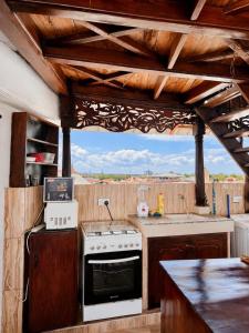 a kitchen with a stove and a counter top at ZANZInest Apartment in Kituoni
