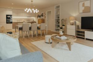 a living room with a table and a dining room at Gerês Thermae Retreat in Geres