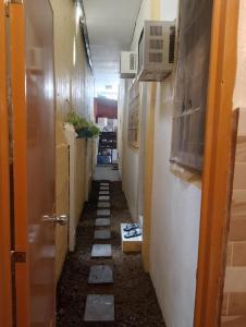 a hallway with a long corridor with a long corridorngthngthngthngthngthngth at Amori Spaces - MRG in Maribago