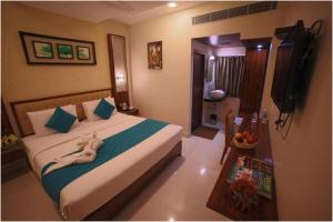 a bedroom with a bed with a towel on it at Hotel President in Madurai