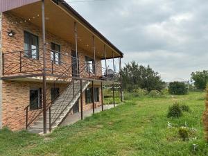a brick building with stairs on the side of it at Baleni Agritourism Guesthouse in Gyulagarak